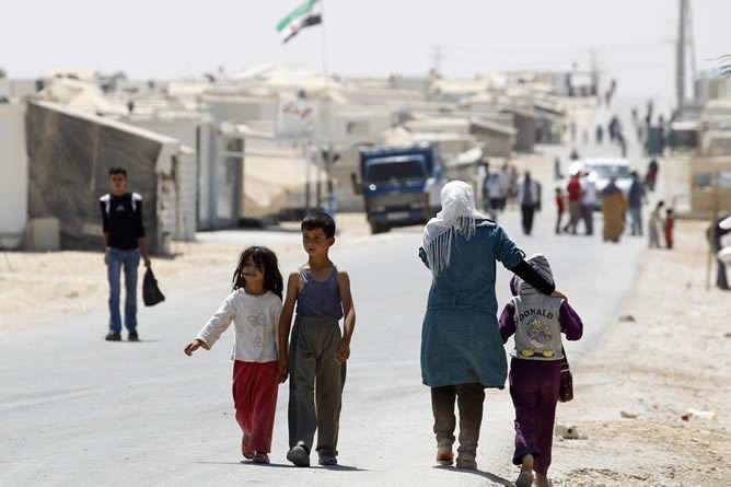 Niños sirios caminan en busca de un refugio que les aleje de su país.