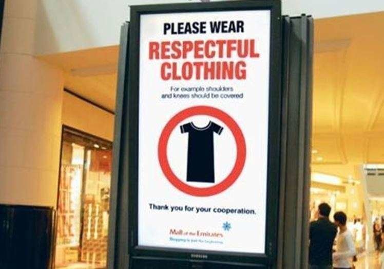 Cartel indicador del Código de Vestimenta en centros comerciales de EAU.