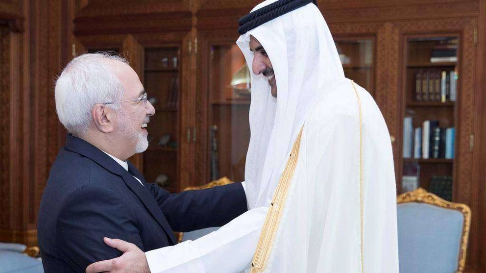 El emir de Qatar estrecha la mano del ministro de Relaciones Exteriores de Irán durante su reunión en Doha.