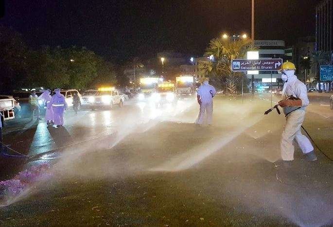 Una imagen de The National de empleados desinfectando una calle.
