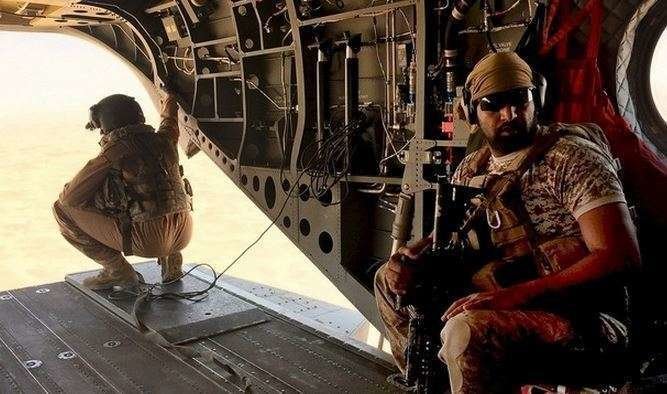 Un soldado y un aviador de Emiratos en un helicóptero Chinook en la zona de Marib. (Reuters)