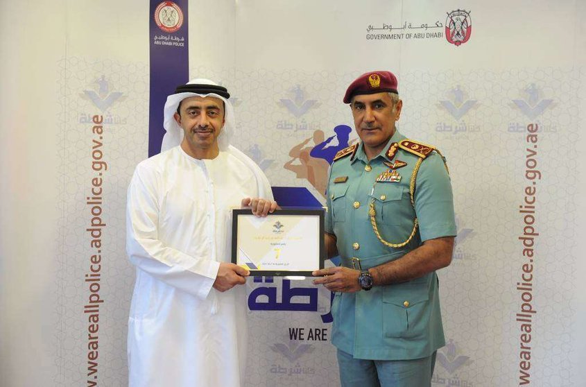 El jeque Abdullah bin Zayed recoge su acreditación como miembro de 'Todos somos Policía' de manos de Mohammed Khalfan Al Rumaithi.