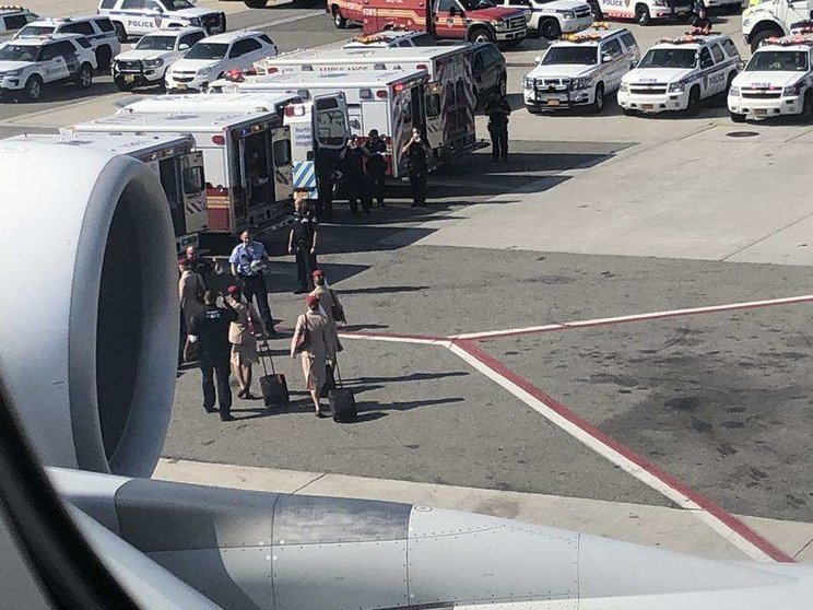 Tripulantes de cabina de Emirates se dirigen a las ambulancias en el aeropuerto de Nueva York.