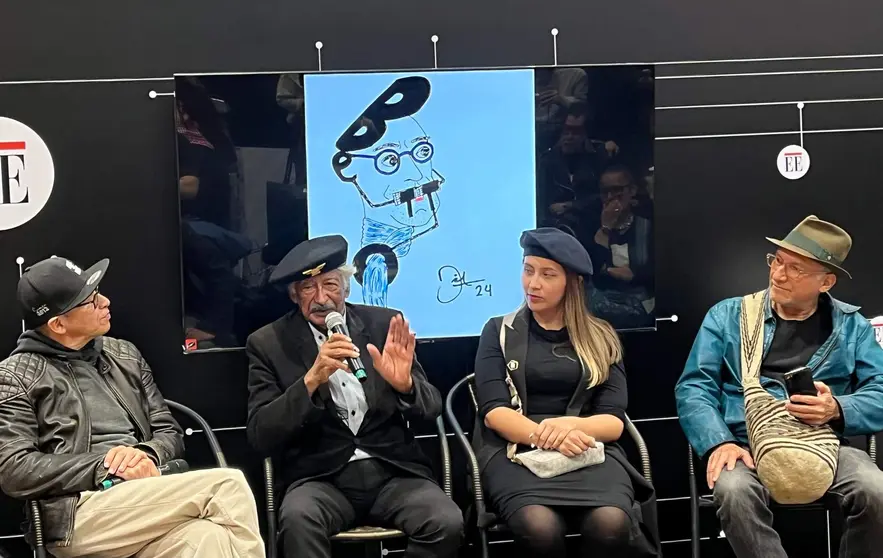 Conversatorio sobre Betto en la Feria del Libro de Bogotá moderado por los periodistas Camila Eslava y Andrés Osorio con la caricatura que Dixon Moya, autor de este texto, ha realizado para El Espectador del prominente ilustrador colombiano recientemente fallecido. (Fuente externa)
