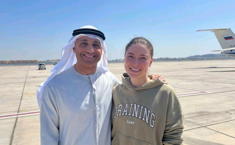 La bailarina de ballet ruso-estadounidense Ksenia Karelina posa junto a un funcionario emiratí. (WAM)