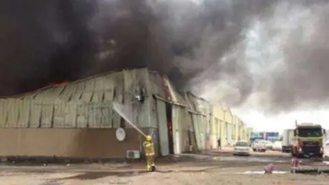 Los bomberos trabajan para apagar el fuego en los almacenes de Al Mina. (Ministerio del Interior, Twitter)