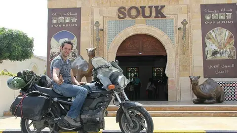 José Ruiz, subido en su vieja BMW K-75 ante el Zoco de Wafi en Dubai. (EL CORREO)