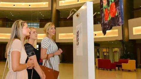 Visitantes observan los bordados durante la inauguración de la muestra en la Paríz-Sorbona de Abu Dhabi. (Manaf K. Abbas)