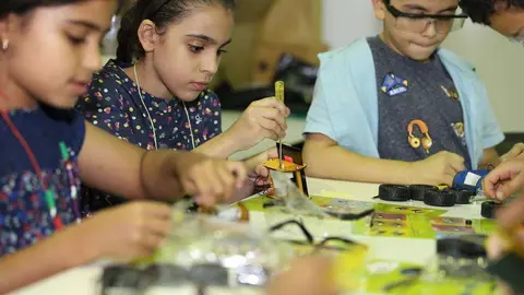 Los niños deben montar los coches con las piezas que les facilita la monitora del taller. (Cedida)
