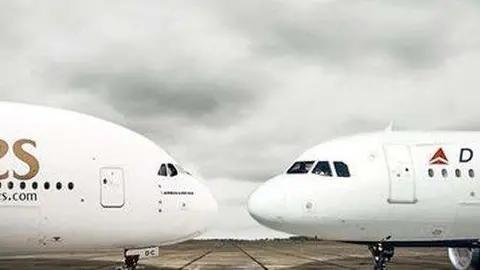 Un avión de Emirates junto a otro de la aerolínea Delta.
