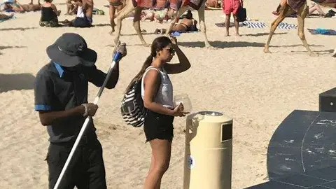 Un trabajador barre la playa de JBR en Dubai Marina. (EL CORREO)