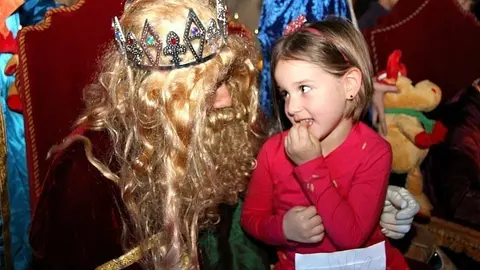 Melchor escucha a una niña durante la noche de Reyes 2018 en Dubai. (EL CORREO)