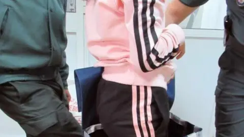 En la imagen de EFE, la niña siria sale del carrito de la compra.