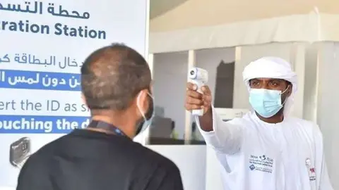 Una persona es sometida a control de temperatura en Emiratos Árabes. (WAM)