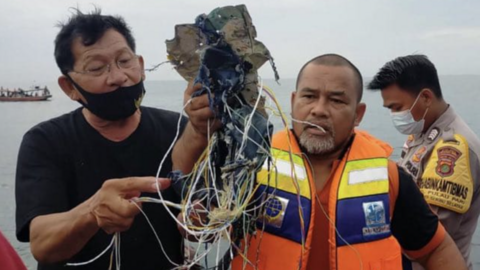 Un funcionario con los escombros que podr&iacute;an ser restos de la aeronave siniestrada. (Twitter)