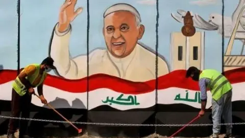 En la imagen de AFP, el papa en un cartel en Irak.