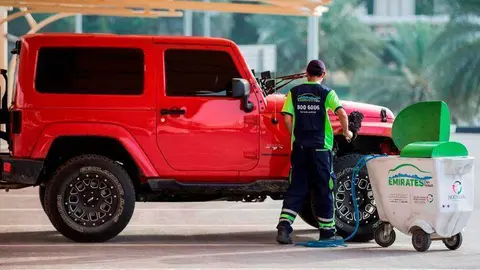 Un trabajador de Emirates Transport lava en seco un vehículo. (WAM)