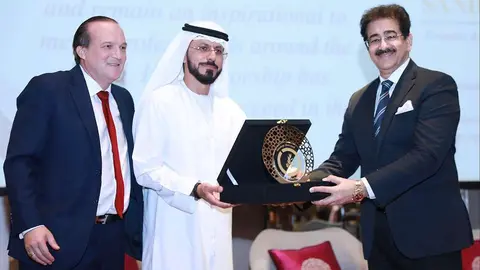 Raphael Nagel -izquierda- y Mohamed Al Ali -derecha- entregan a Sandeep Marwah la distinción como Personalidad Más Inspiradora de 2021. (Cedida)