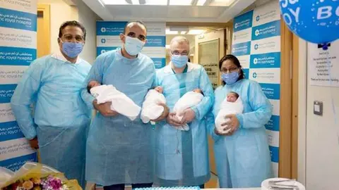 Los médicos posan con los cuatrillizos. (Fuente externa)