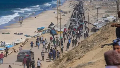 Una imagen de X de palestinos por una carretera de Gaza.
