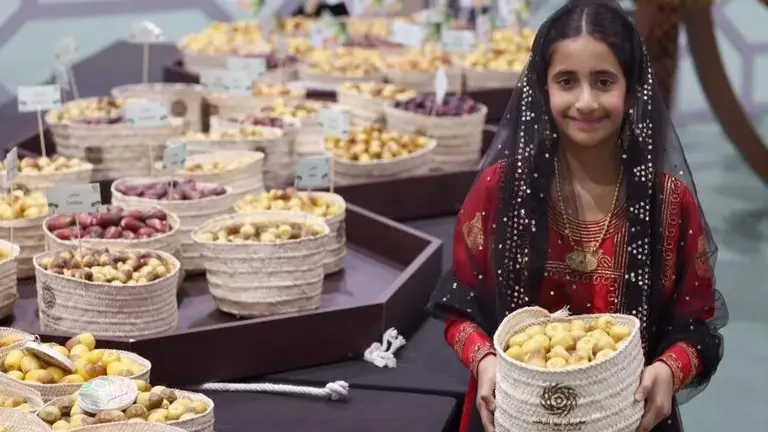 Una ni&ntilde;a emirat&iacute; presenta d&aacute;tiles en el Festival de Liwa. (Abu Dhabi Media Office)