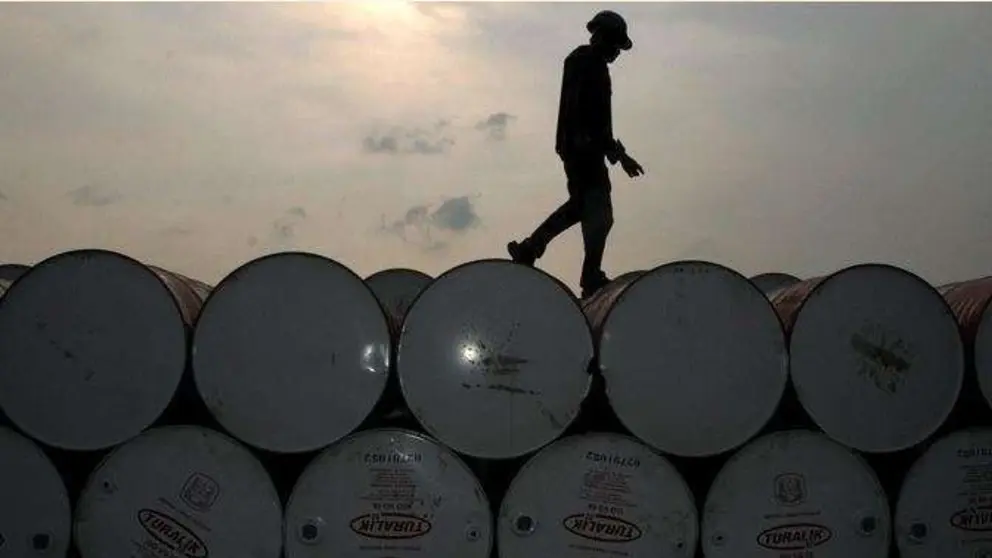 Un trabajador camina por barriles de petr&oacute;leo. (Fuente externa)