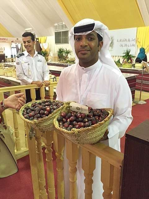 Un expositor muestra dos cestos de espectaculares dátiles en Liwa. (EL CORREO)